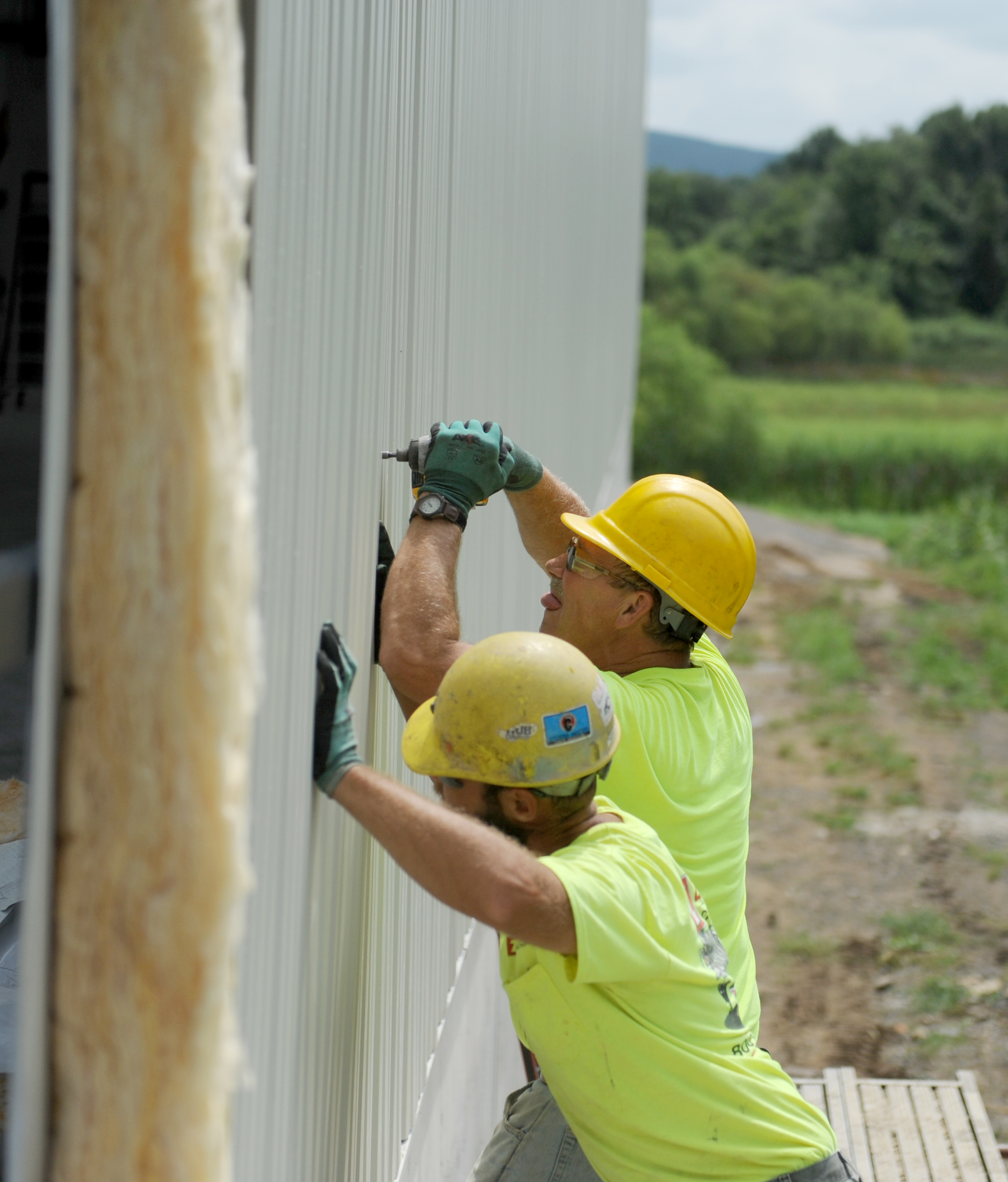 Metal siding is put into place on a new warehouse.
